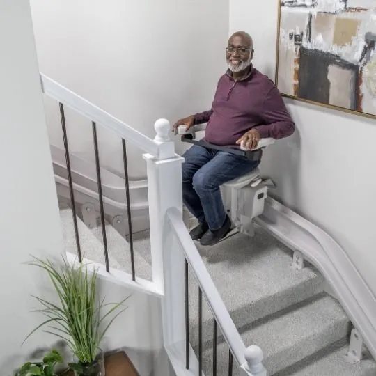 Bruno Elite curved stair lift on a rail made for a turning staircase